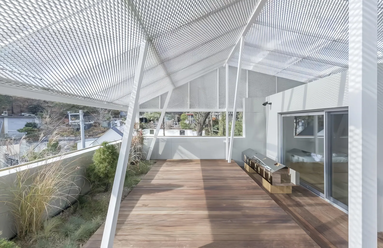 Expanded metal canopy and facade mesh balancing daylight airflow and privacy