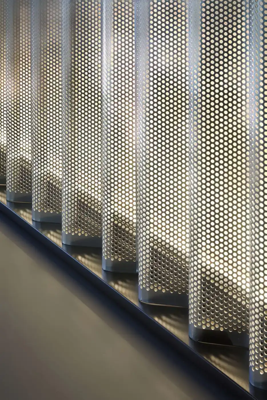 Perforated metal wall screen for a museum or exhibition interior