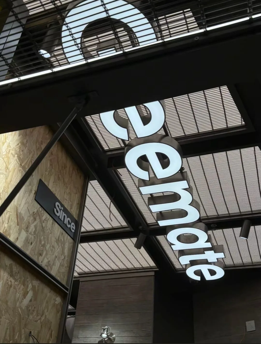 Cable rod wire mesh used above illuminated retail signage