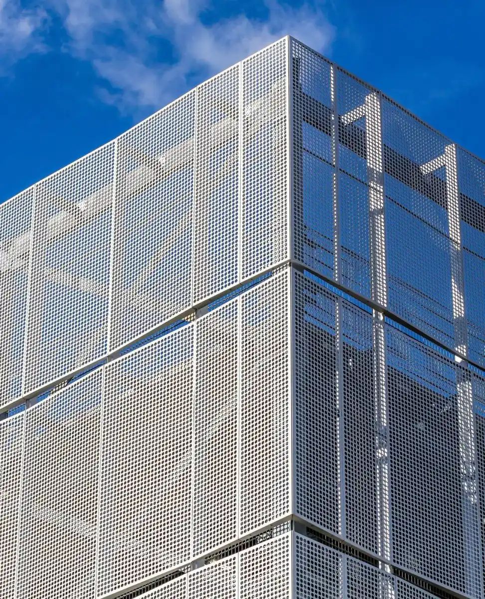Perforated metal parking screen panels with repeated circular openings