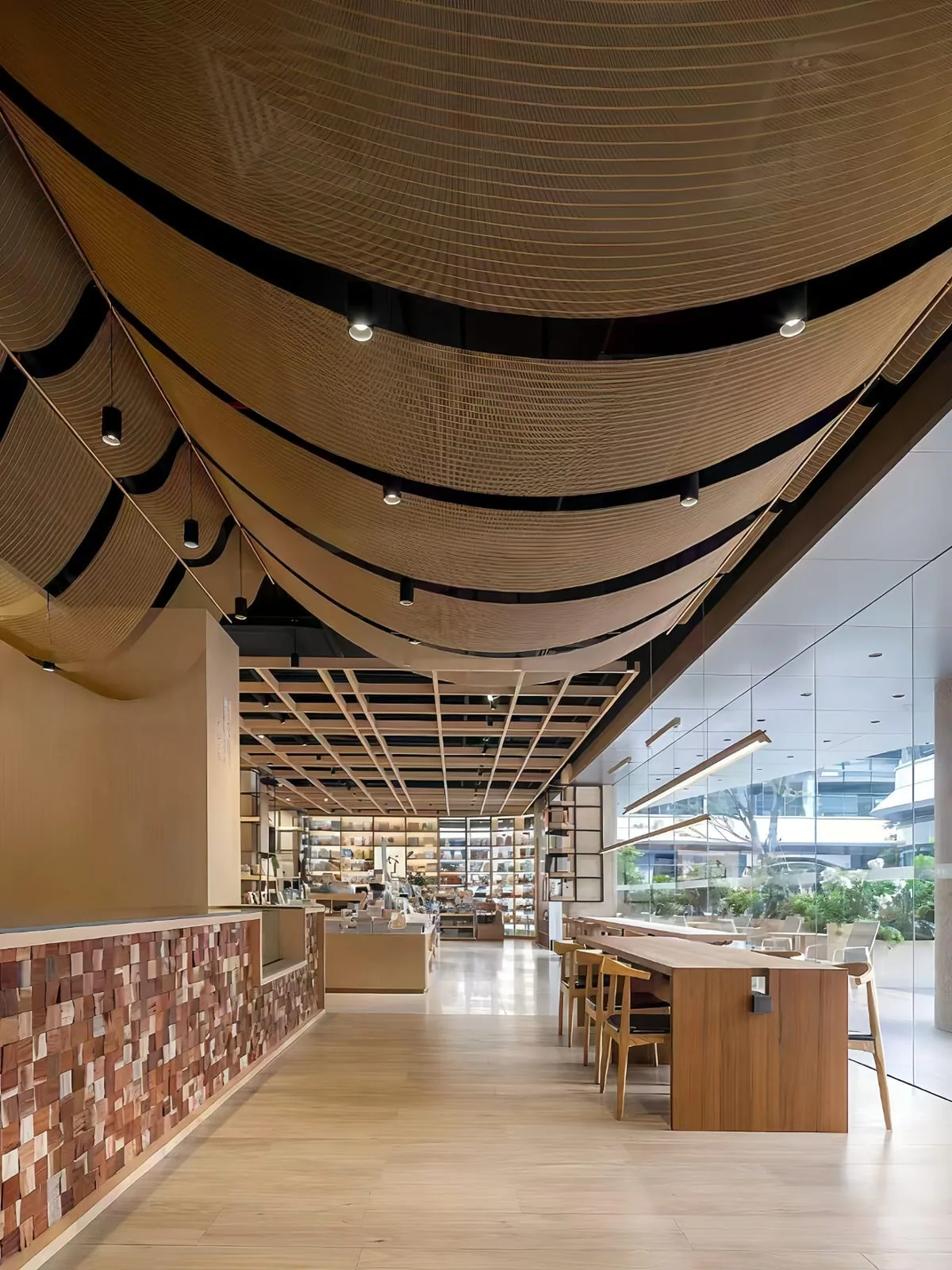 Suspended architectural metal mesh ceiling feature with curved hanging layers